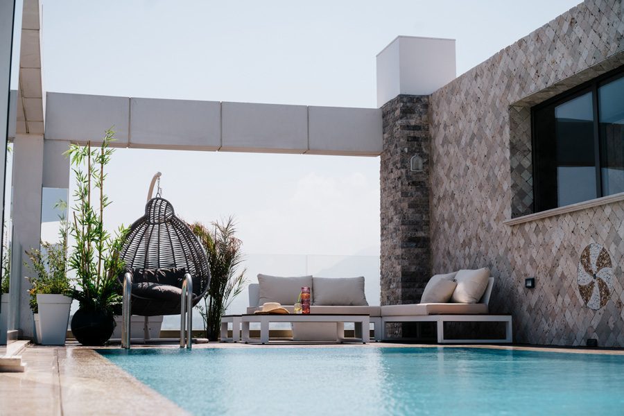 Pool area with hanging chairs