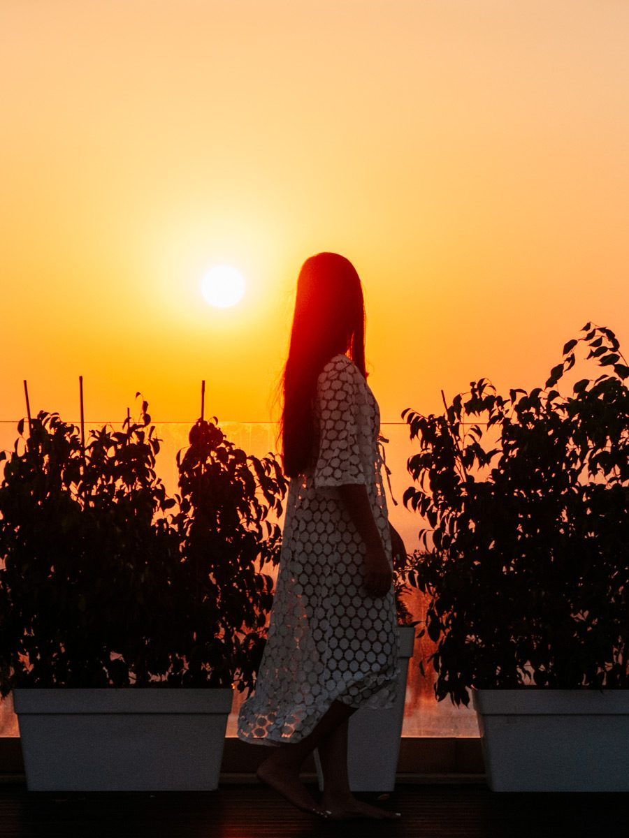 Woman at the pool at sunset